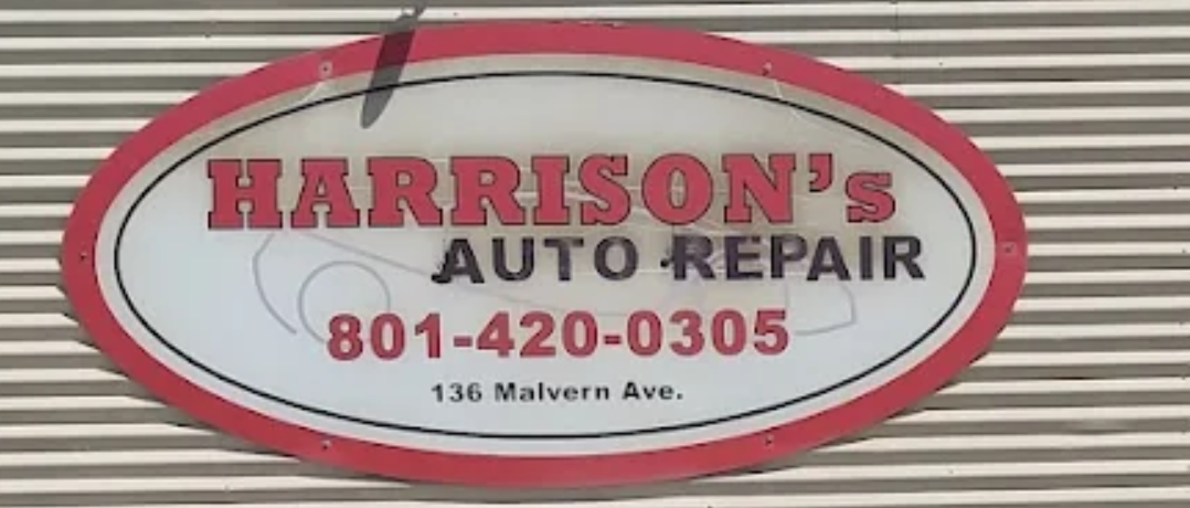 The red oval Harrison's Auto Repair sign on the shop wall